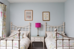 Twin bedroom with pink accents of colour